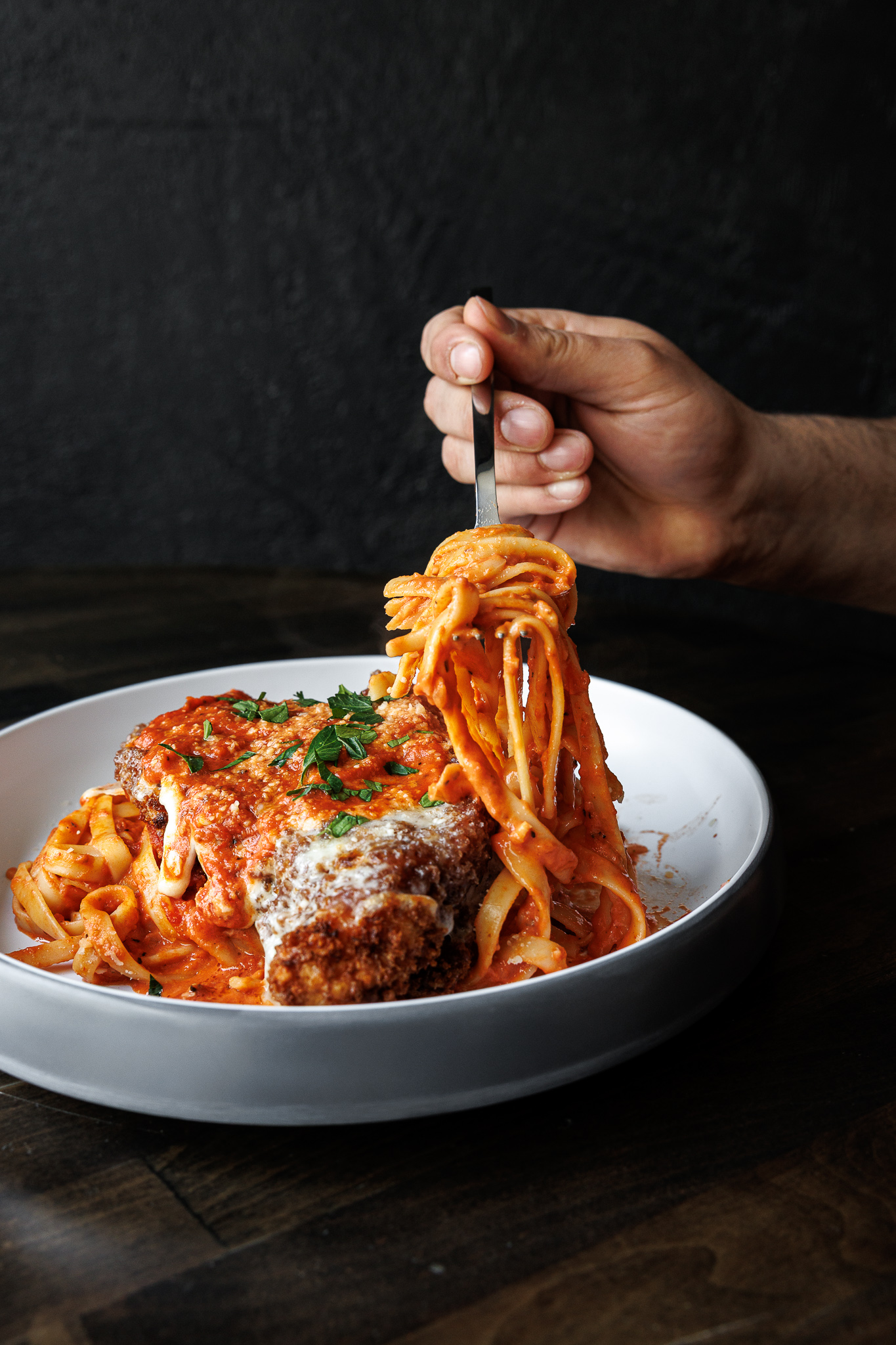 Chicken parmesan over fettuccine with rosé sauce