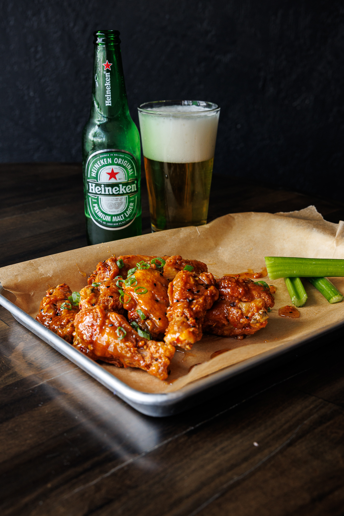 Buffalo wings paired with a cold Heineken